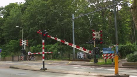 Railroad-barriers-on-a-railroad-crossing-closing-in-a-small-Dutch-town-in-the-summer