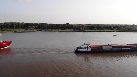 Aerial-Starboard-View-Of-Ensamble-Container-Ship-Going-Past-Along-Oude-Maas