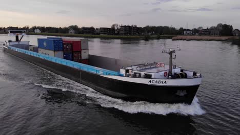 Acadia-Vessel-With-Intermodal-Containers-Sailing-Across-The-River-In-Netherlands