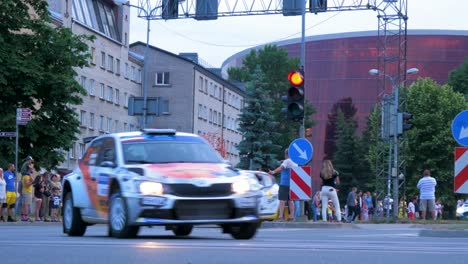 FIA-European-Rally-Trophy-2021-festive-start-and-cars-parade-at-streets-of-Liepaja-,-rally-cars-passing-spectators,-low-angle-tracking-shot