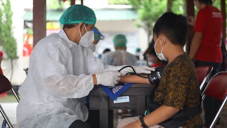 Yogyakarta,-Indonesia---Dec-20,-2021-:-an-elementary-school-boy-is-being-screened-to-receive-the-covid-19-vaccine