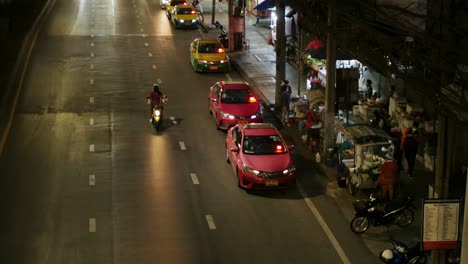 Taxis-line-up-to-pick-up-passengers-in-front-of-a-shopping-mall-in-the-evening-after-work-and-the-situation-of-the-Covid-19-epidemic-in-Bangkok,-Thailand
