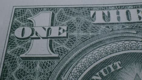 Close-Up-Pan-Left-of-the-Number-One-on-the-Back-of-a-One-Dollar-Bill