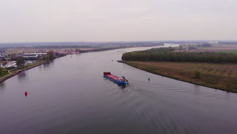 Aerial-Drone-View-Over-Torpo-Cargo-Ship-Approaching-Bend-On-Oude-Maas-Near-Barendrecht-On-Cloudy-Day