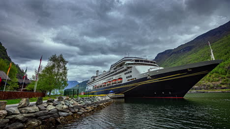 Luxury-cruise-liner-MS-Queen-Elizabeth-ship-docked-and-waiting-for-passergers-in-timelapse-in-Flam-port-in-Norway