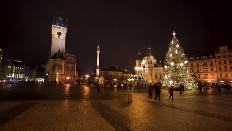 People-walking-across-Old-town-square-with-Christmas-tree,night-Prague