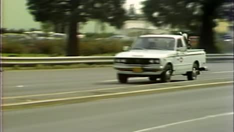 PANNING-SHOT-OF-1970S-CARS-ON-THE-ROAD