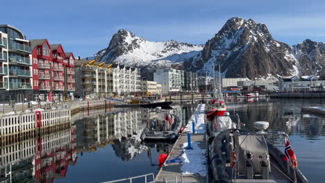 Peaceful-view-of-Svolvaer-Harbor-on-a-sunny-day,-Buildings-reflecting-on-the-water-surface,-Lofoten-Island,-Norway-4k