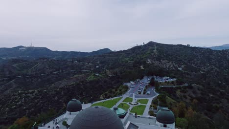 Luftaufnahme-Des-Griffith-Observatoriums-Mit-Bergen-Und-Hollywood-Schild-Am-Horizont