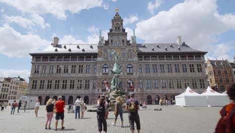 People-visit-the-city-hall-and-Brabo-monument-on-Grote-Markt-square-in-Antwerp-city,-Belgium
