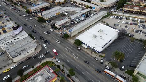 Aerial-view-overlooking-SWAT-vehicles-on-streets-of-Los-Angeles,-USA---circling,-drone-shot