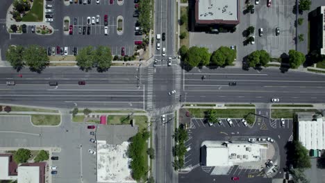 Commuter-Traffic-from-Cars-Driving-through-City-Street-Intersection---Overhead-Bird's-Eye-Aerial-View
