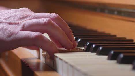 A-Hand-Plays-One-Chord-On-An-Piano,-Close-Up