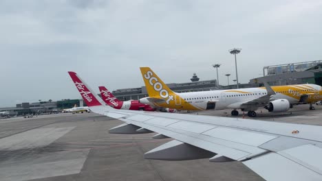 AirAsia-flight-pushback-at-Changi-Airport-terminal-1-on-a-sunny-morning
