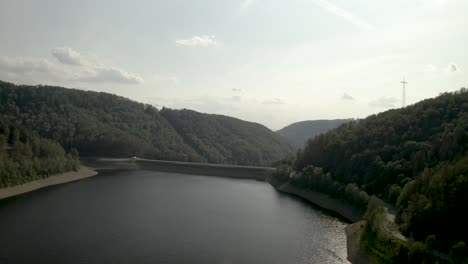 Scenic-Drone-Shot-of-a-beautiful-lake-at-sunset-in-the-Harz-National-Park,-Germany,-Europe