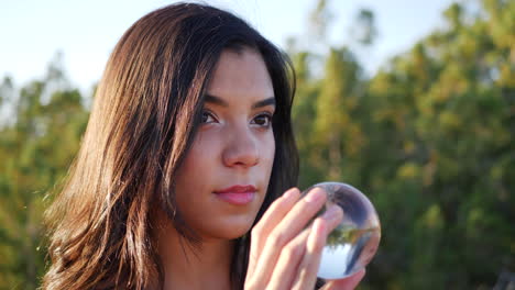 A-beautiful-woman-in-a-mystical-fantasy-world-with-her-eyes-staring-at-a-magic-crystal-ball-CLOSE-UP