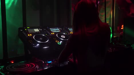Shot-from-the-back-of-a-female-DJ-playing-in-a-club