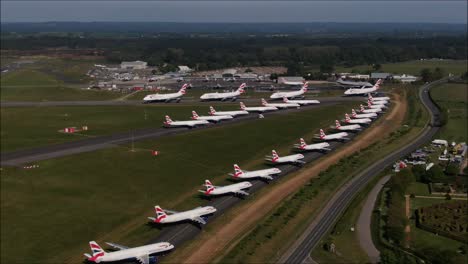 Aerial-drone-shot-of-Planes-parked-up-on-taxiway-at-Bournemouth-Airport-because-of-COVID-19-lockdown