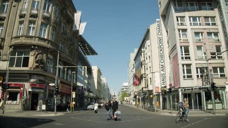 Crossing-in-Berlin-with-Historic-Checkpoint-Charlie-Area-in-Background
