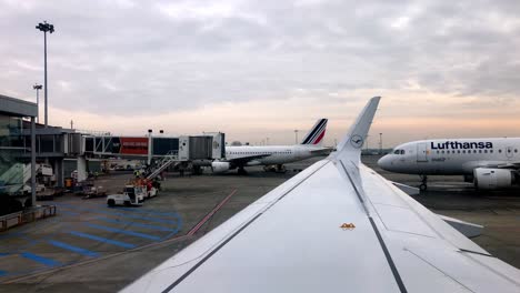 Wing-view-at-the-Toulouse-airport-of-busy-tarmac-in-Blagnac,-France