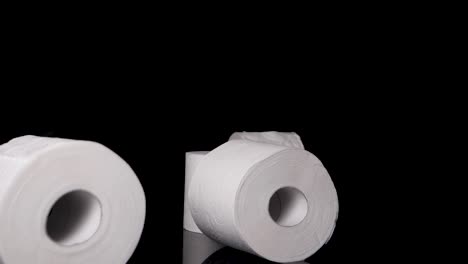 Toilet-Paper-Rolls-Falling-in-Slow-Motion-in-front-of-Black-Backgound