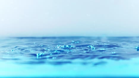 The-clean-water-surface-in-slow-motion-fills-the-screen-with-water-splashing-shop-the-water-drop-and-waving-liquid-surface-with-an-air-bubble