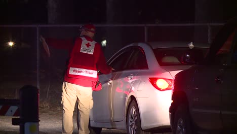 RED-CROSS-VOLUNTEER-GUIDING-DRIVER-DURING-EVACUATION