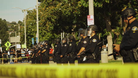 Wide-Profile-Shot-of-Police-Line-Behind-Police-Tape-at-Black-Lives-Matter-Protest,-Whittier,-CA