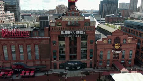 Asecending-aerial,-Barnes---Noble-Booksellers-and-Hard-Rock-Cafe-at-Baltimore-Inner-Harbor,-Phillips,-famous-historical-electric-power-plant