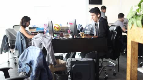 Young-tech-savvy-employees-working-on-computers-in-a-startup-company