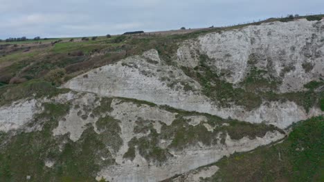 Descending-drone-shot-of-zig-zag-pathway-on-the-side-of-white-cliffs-of-dover