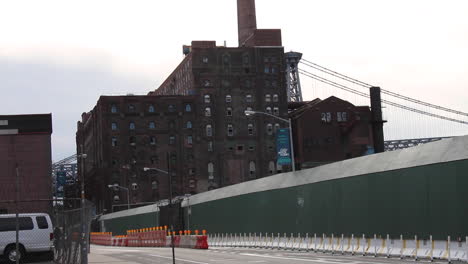 Gentrification-at-Work,-Cars-and-Bikers-Go-By-Domino-Factory-Redevelopment-in-Williamsburg-Brooklyn