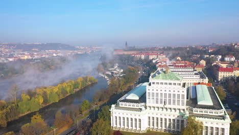 A-huge-spring-evaporation-of-Vltava-river-in-haze,Prague-city,Czechia,aerial-view