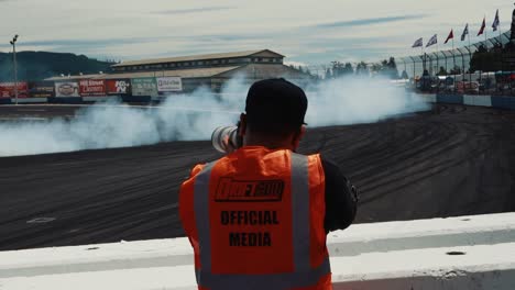 Man-Taking-Photos-of-a-Car-Drifting-Around-the-Track-at-Driftcon