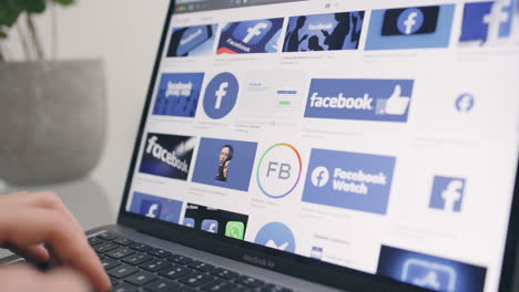 Close-up-of-browsing-through-images-of-Facebook-logos-on-MacBook