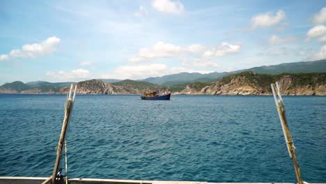 Trip-on-fishing-boat-pov,-calm-azure-sea-scenery,-Vinh-Hy-Bay,-Vietnam