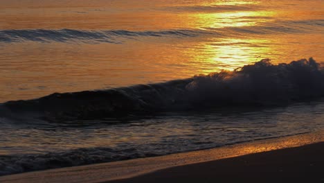 Calm-sea-at-dawn-reflecting-sunrise-in-golden-waves,-mediterranean-sea,-spain