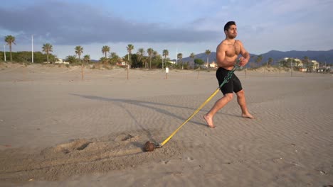 exercise-on-the-beach-with-a-long-stride-offering-resistance-with-weight