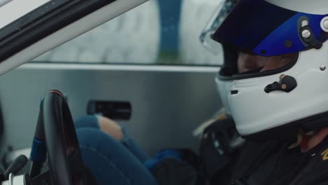 Driver-and-Passenger-With-Racing-Helmets-Inside-Luxury-Sports-Car,-Close-Up-Slow-Motion