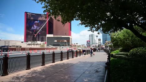 Tourists-walking-on-sidewalk-across-from-Resorts-World-on-the-Las-Vegas-Strip