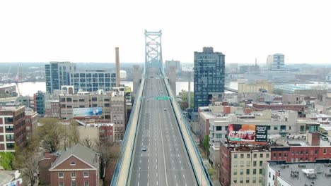 Aerial-view-of-low-traffic-on-the-Benjamin-Franklin-Bridge,-in-Philadelphia---circling,-drone-shot