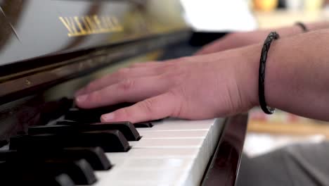 Close-up-of-whit-caucasian-hands-playing-piano-quickly-and-expertly