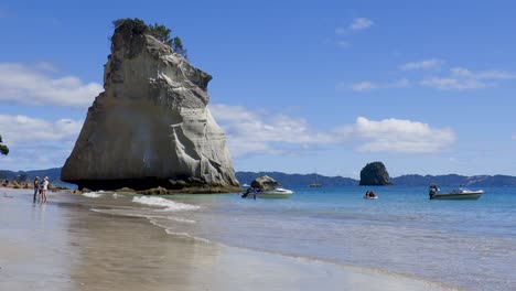 Low-down-wide-shot-of-waves-at-Te-Hoho-rock-and-Cathedral-cove-beach