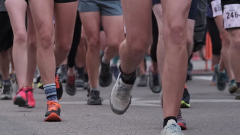Knee-level-shot-of-marathon-runners-running-during-race