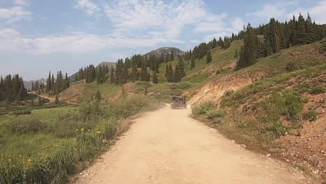 POV-while-following-a-4WD-vehicle-onto-the-start-of-Black-Bear-trail-through-the-San-Jan-Mountains-near-Telluride-Colorado