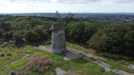 Bidston-hill-disused-rural-flour-mill-restored-traditional-wooden-sail-windmill-Birkenhead-aerial-view-pull-away-reveal