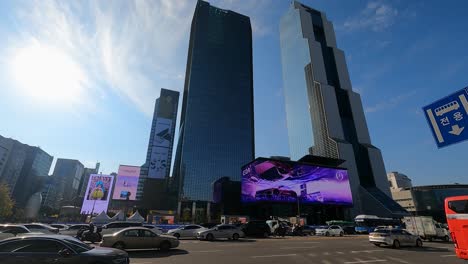 Traffic-time-lapse---World-Trade-Center-Seoul---SMtown-Coex-Artium-with-Largest-curved-LED-Digital-outdoor-Billboard-Screen,-Trade-Tower-And-Parnas-Skyscrapers,-South-Korea
