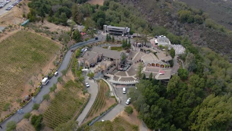 Aerial-drone-view-circling-away-from-the-mountain-winery,-in-the-highlands-of-Saratoga