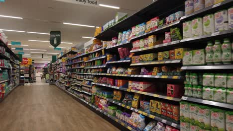 Selection-of-everyday-supermarket-grocery-products-on-baby-food-aisle-shelving