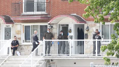 Police-officers-investigate-crime-scene-on-Residential-Building---Longueuil